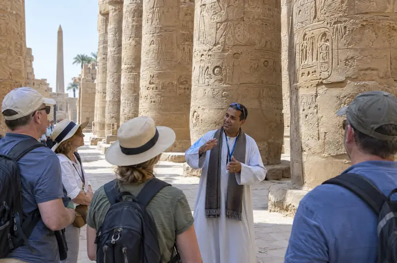A guide with a group at Karnak temple